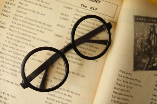Eyeglasses on the old opening  book.