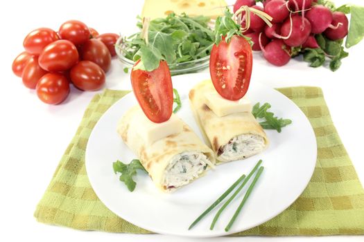 stuffed cheese crepe rolls on a light background