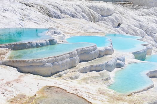 Blue water travertine pools and terraces in Pamukkale, Turkey