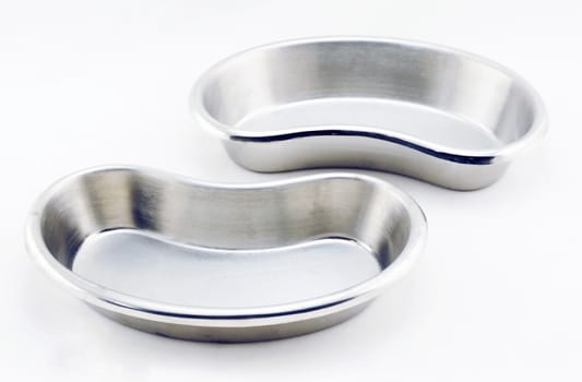 Two emesis stainless steel placed close together on white background.                               