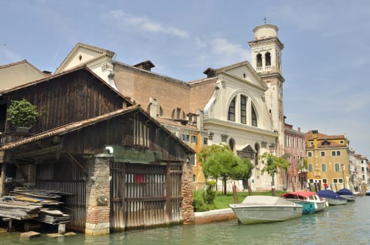 Church and the repair yard of the gondolas in the canal of San Trovaso in the Dorsoduro district in Venice, Italy.  