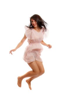 A caucasian brunette jumping happily in her pink outfit