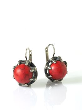 red silver earring over white with shadows
