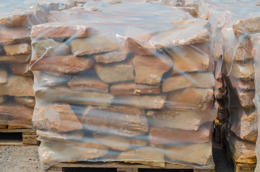 Drywall stones from German sandstone on a pallet ready for processing