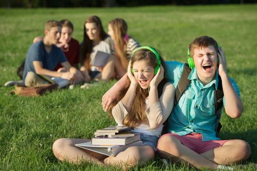 Pair of happy Caucasian teens singing out loud