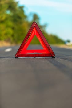 Red triangle of a car on the road