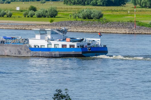 Small chemical tanker with bow wave.