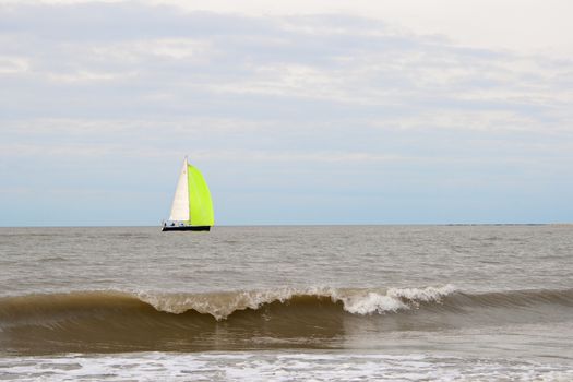 sailboat on the sea with waves