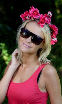 Pretty blond woman with a wreath of pretty spring flowers on her head
