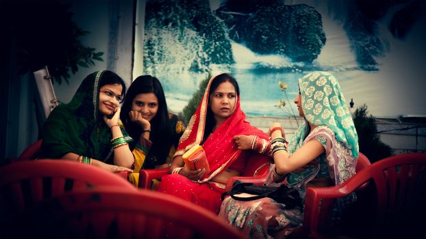 Happy Indian womens talking in colourful sarees