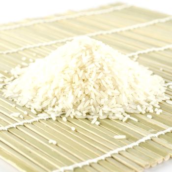 uncooked rice on wooden pad