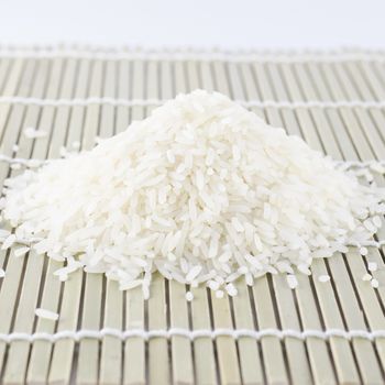 uncooked rice on wooden pad