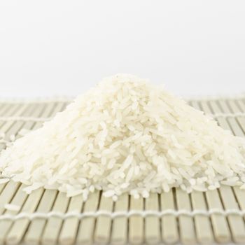 uncooked rice on wooden pad