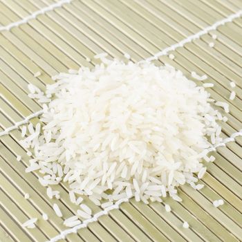 uncooked rice on wooden pad