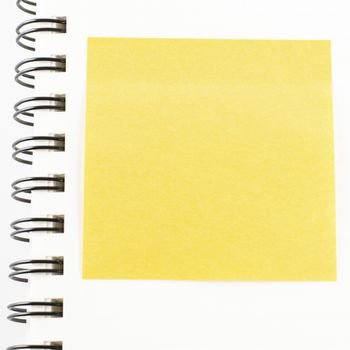 orange sticker note on notebook on a white background