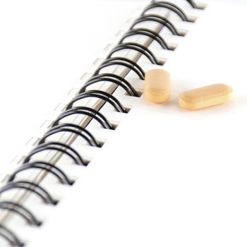 two pills on notebook concept seriousness