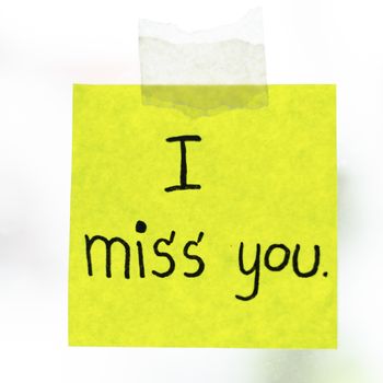 I miss you word sticky note on window mirror