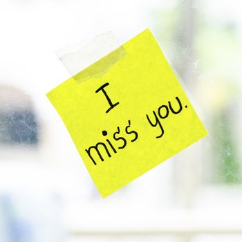 I miss you word sticky note on window mirror