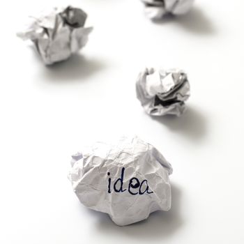 white crumpled paper ball focus idea word on a white background