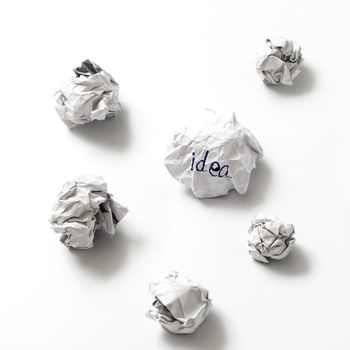 white crumpled paper ball focus idea word on a white background