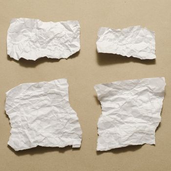 piece of white crumpled paper on brown background
