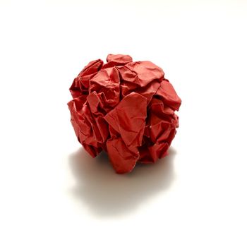 red crumpled paper ball on a white background