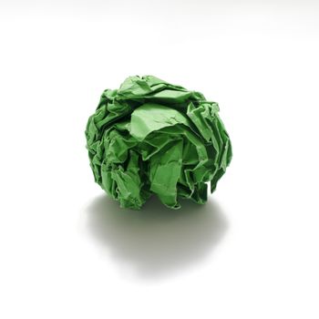 green color crumpled paper ball on a white background