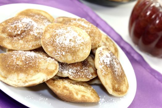 Poffertjes with powdered sugar and fruit jelly