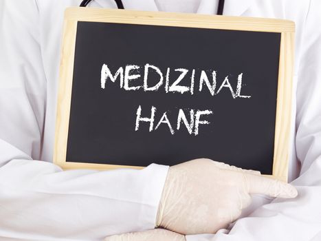 Doctor shows information on blackboard: medical marijuana in german