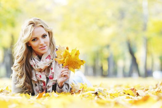Portrait of beautiful young woman outdoors in autumn park