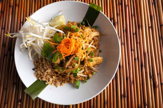 Chicken pad Thai dish of stir fried rice noodles with a contemporary presentation.