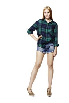 Studio shot of attractive young woman in shirt and shorts.