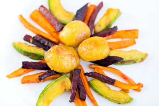 Plate ful of vegetable cooked with potato, beetroot, avocado and carrot chips