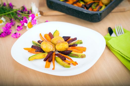 Plate ful of vegetable cooked with potato, beetroot, avocado and carrot chips