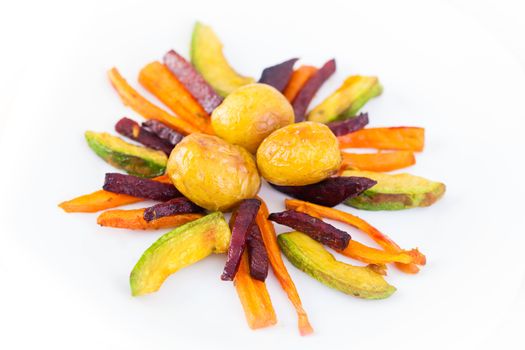 Plate ful of vegetable cooked with potato, beetroot, avocado and carrot chips