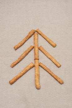 Christmas card, tree made of grissini on linen fabric