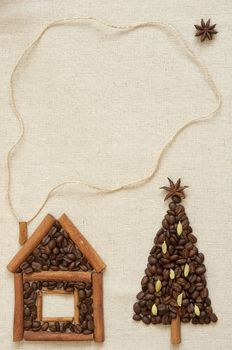 House made of cinnamon and coffee and christmas tree made of coffee