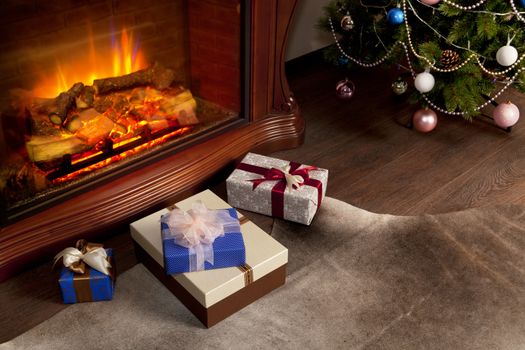 Christmas gift boxes and New Year tree in the interior with fireplace