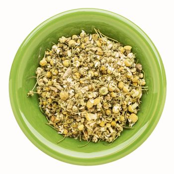 chamomile herb on an isolated green bowl