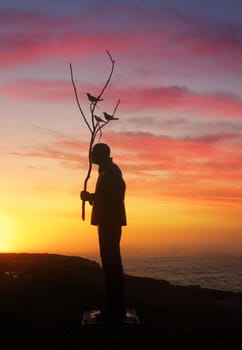 BONDI, AUSTRALIA - OCTOBER 23, 2014; Sculpture by the Sea Annual free public event 2014.  Exhibit titled Man playing with Birds  by artist Wang Shugang, China,  Materials, stainless steel, titanium, Price $120000