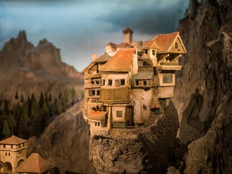 Miniature model of a small village on top of a rocky section in the mountains