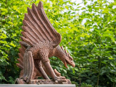Giant bronze statue of some sort of evil looking bird