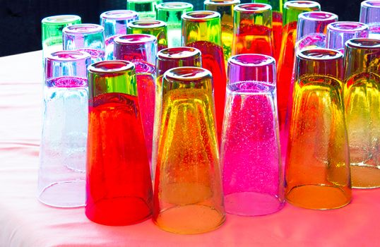 Beautiful colored glasses with the original invoice in the form of bubbles in the caf�� on the surface of the table.