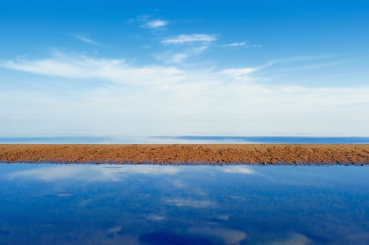 Sandy beach, azure sky and blue sea