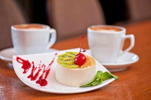 tasty fruit dessert with cherry and kiwi with coffee