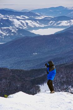 Tourist taking photos on mountain.