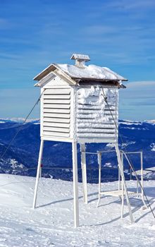 Meteorological station, frozen thermometer in winter.