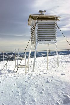 Winter weather station on mountain.
