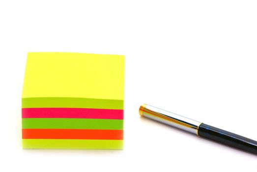 Stack of post it and pen, close up image.