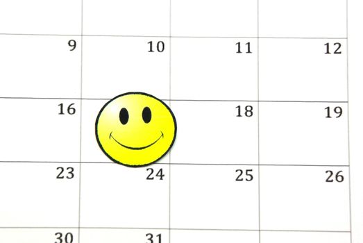 Smile face on a calendar, close up image.